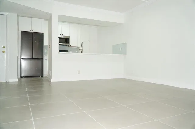 a view of a kitchen with a sink and a refrigerator