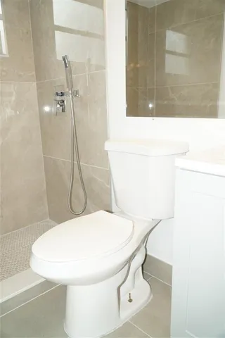 a white toilet sitting next to a bathroom sink