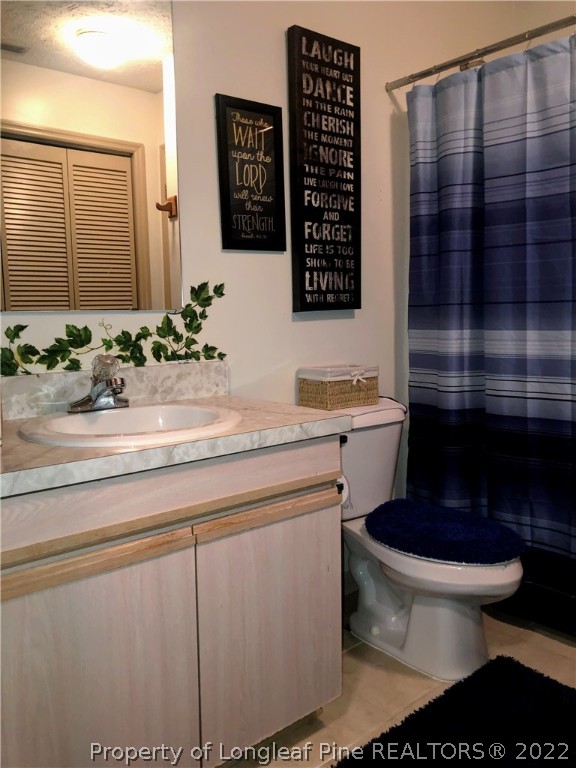 1828 Sardonyx Road, Unit 3 Fayetteville, NC 28303 - Photo 13 of 22 a bathroom with a toilet a sink and mirror