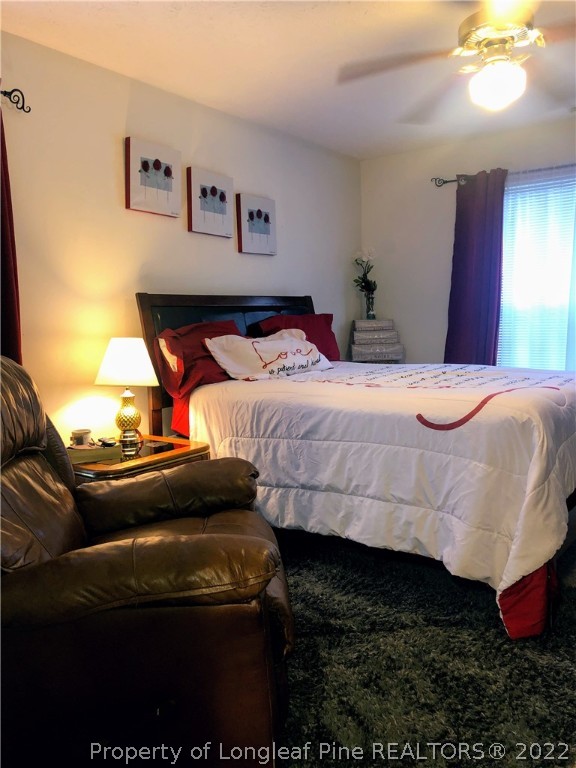 1828 Sardonyx Road, Unit 3 Fayetteville, NC 28303 - Photo 17 of 22 a bedroom with a bed and a chandelier