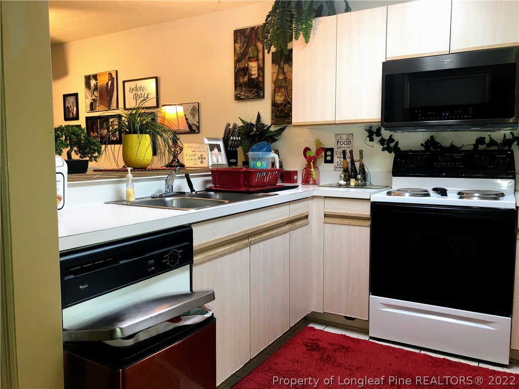 1828 Sardonyx Road, Unit 3 Fayetteville, NC 28303 - Photo 21 of 22 a kitchen with a sink and a stove top oven