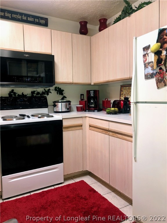 1828 Sardonyx Road, Unit 3 Fayetteville, NC 28303 - Photo 22 of 22 a kitchen with stainless steel appliances a stove a microwave and cabinets