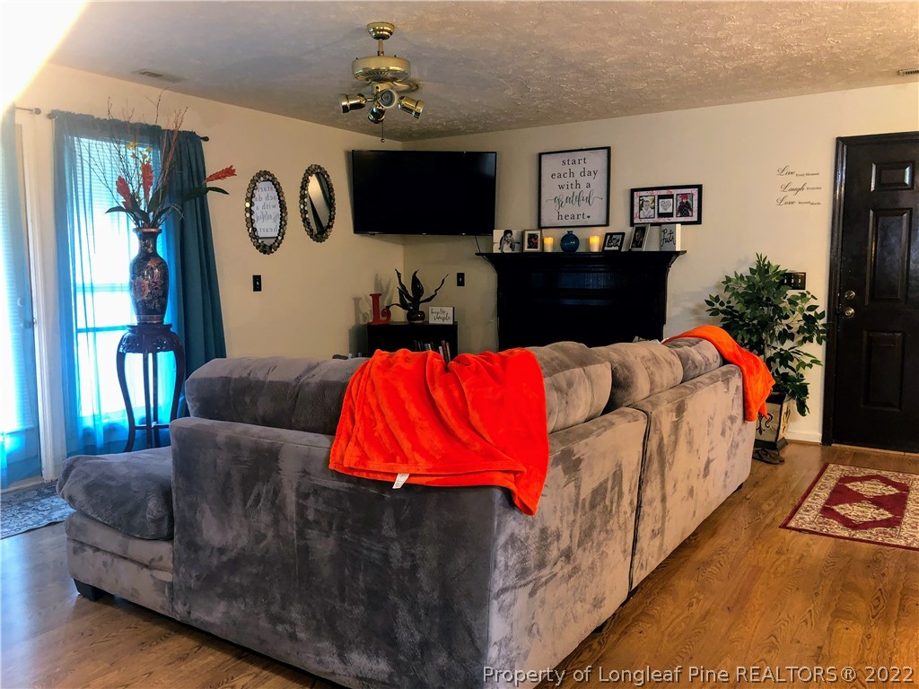 1828 Sardonyx Road, Unit 3 Fayetteville, NC 28303 - Photo 7 of 22 a living room with furniture and a flat screen tv