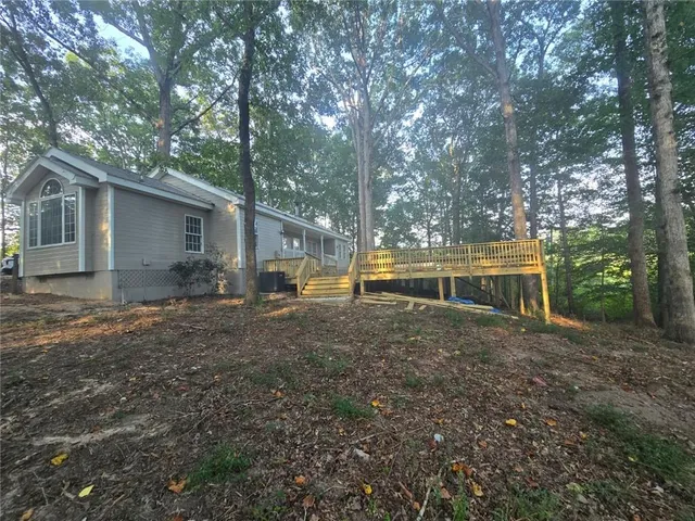 a view of house with outdoor space and garden