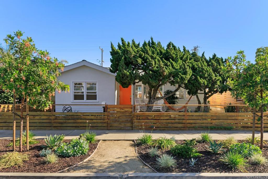 a front view of a house with a garden
