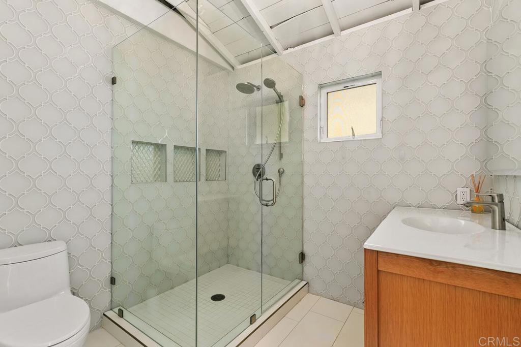 721 3rd Street Encinitas, CA 92024 - Photo 17 of 36 a bathroom with a shower a toilet and sink