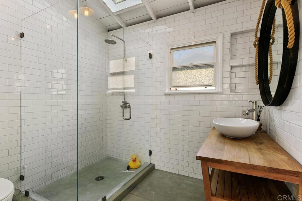 721 3rd Street Encinitas, CA 92024 - Photo 18 of 36 a bathroom with a sink a toilet and shower