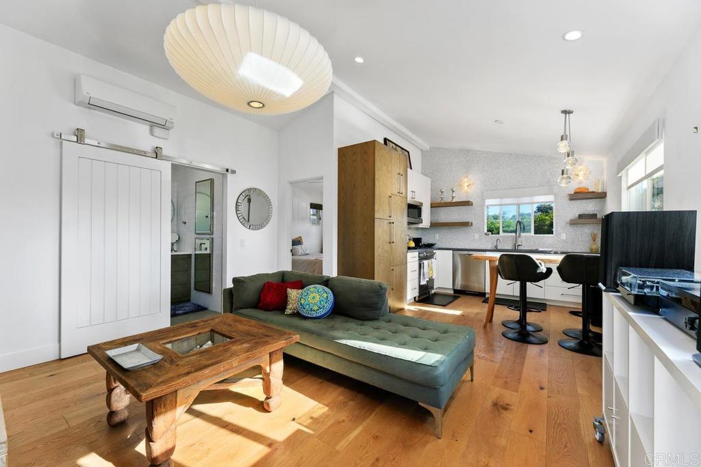 721 3rd Street Encinitas, CA 92024 - Photo 25 of 36 a living room with furniture and a flat screen tv