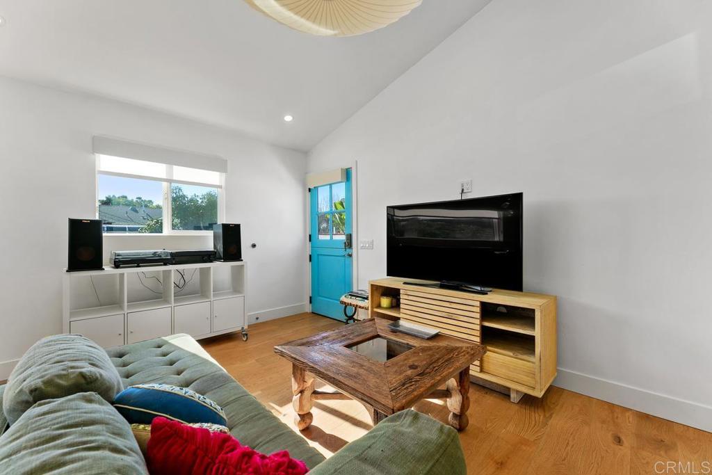 721 3rd Street Encinitas, CA 92024 - Photo 26 of 36 a living room with a bed furniture and a flat screen tv
