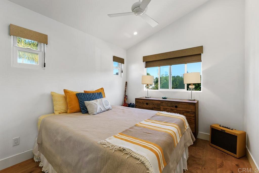 721 3rd Street Encinitas, CA 92024 - Photo 31 of 36 a bedroom with a bed and wooden floor