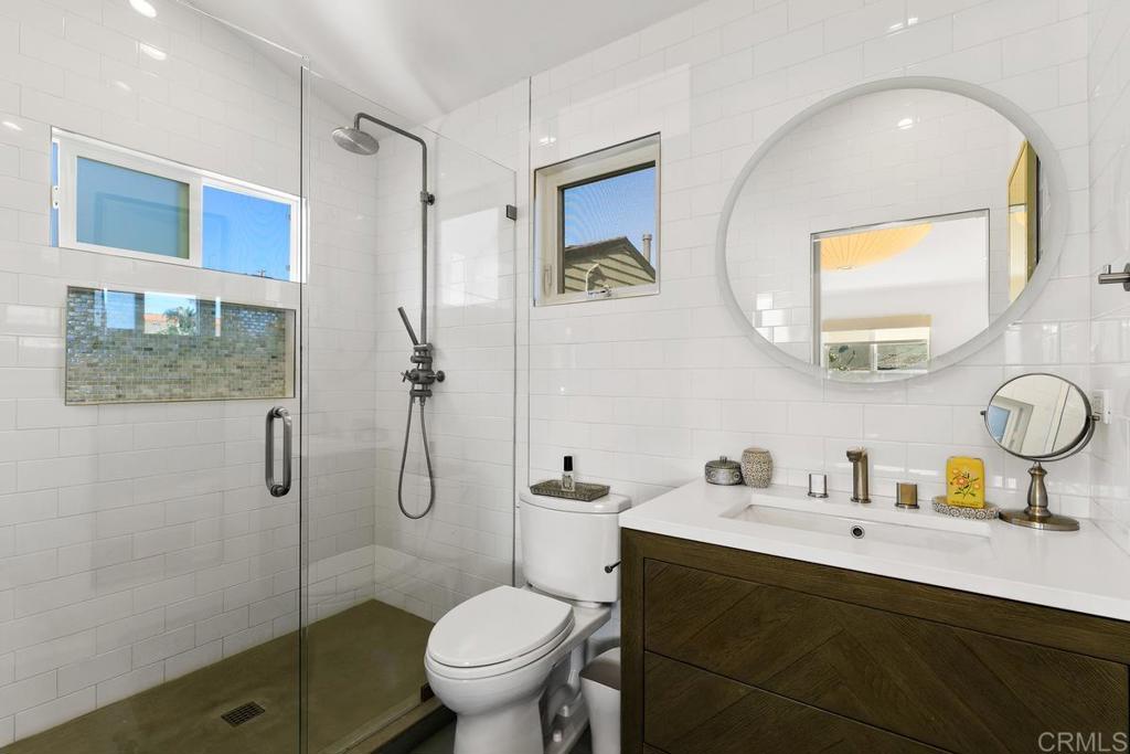 721 3rd Street Encinitas, CA 92024 - Photo 33 of 36 a bathroom with a sink toilet and shower