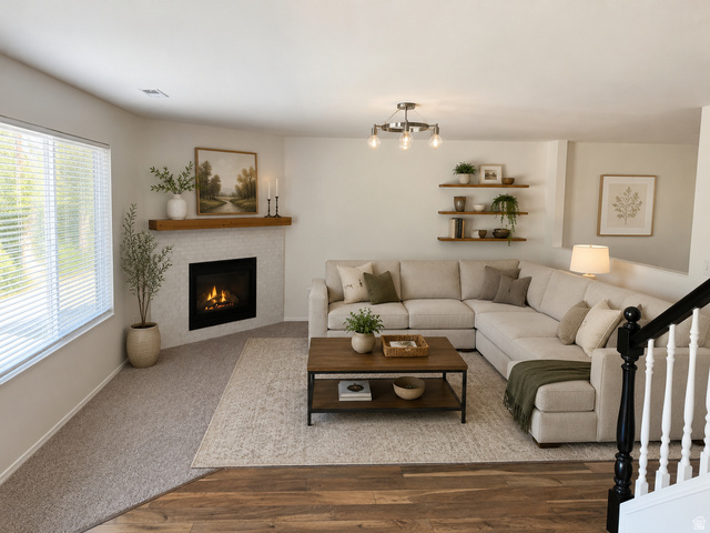 1038 West 950 South Springville, UT 84663 - Photo 8 of 14 Living area featuring a corner fireplace with a wood mantle, large windows with blinds, and built-in wood shelving