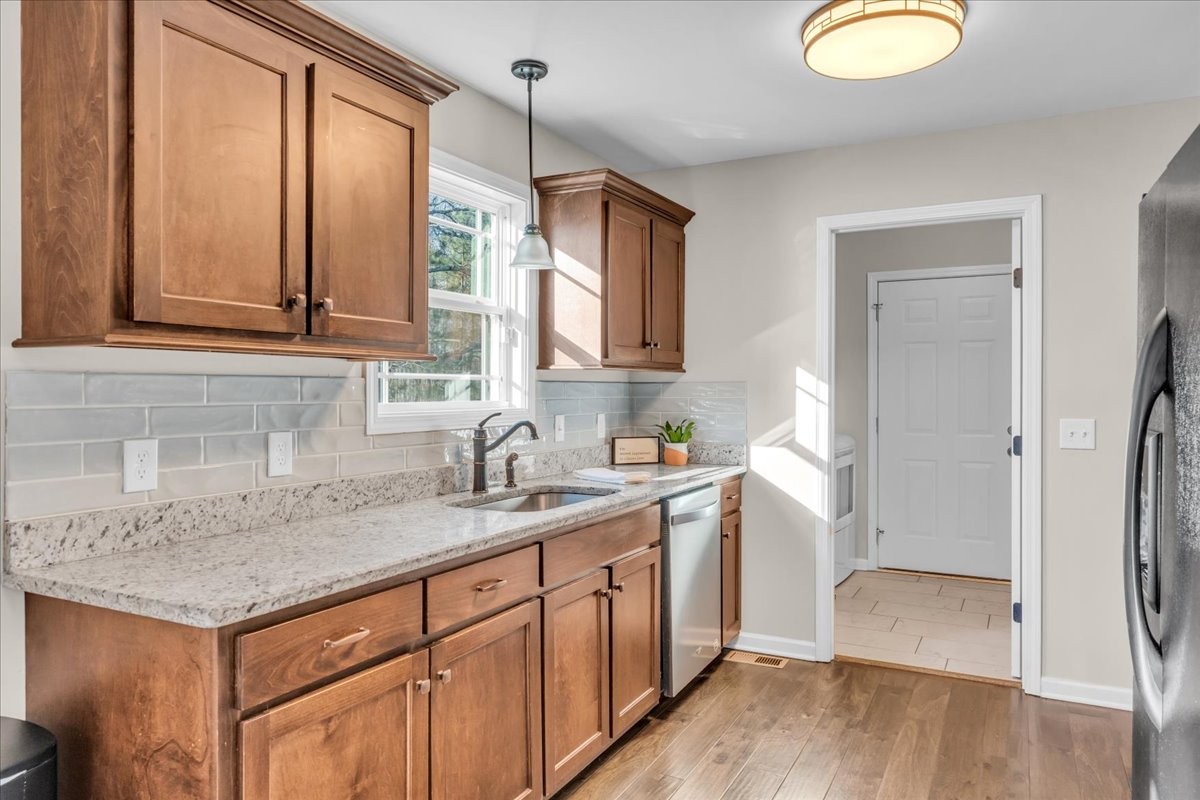 1554 South Spring Street Manchester, TN 37355 - Photo 14 of 33 a kitchen with a sink cabinets and wooden floor