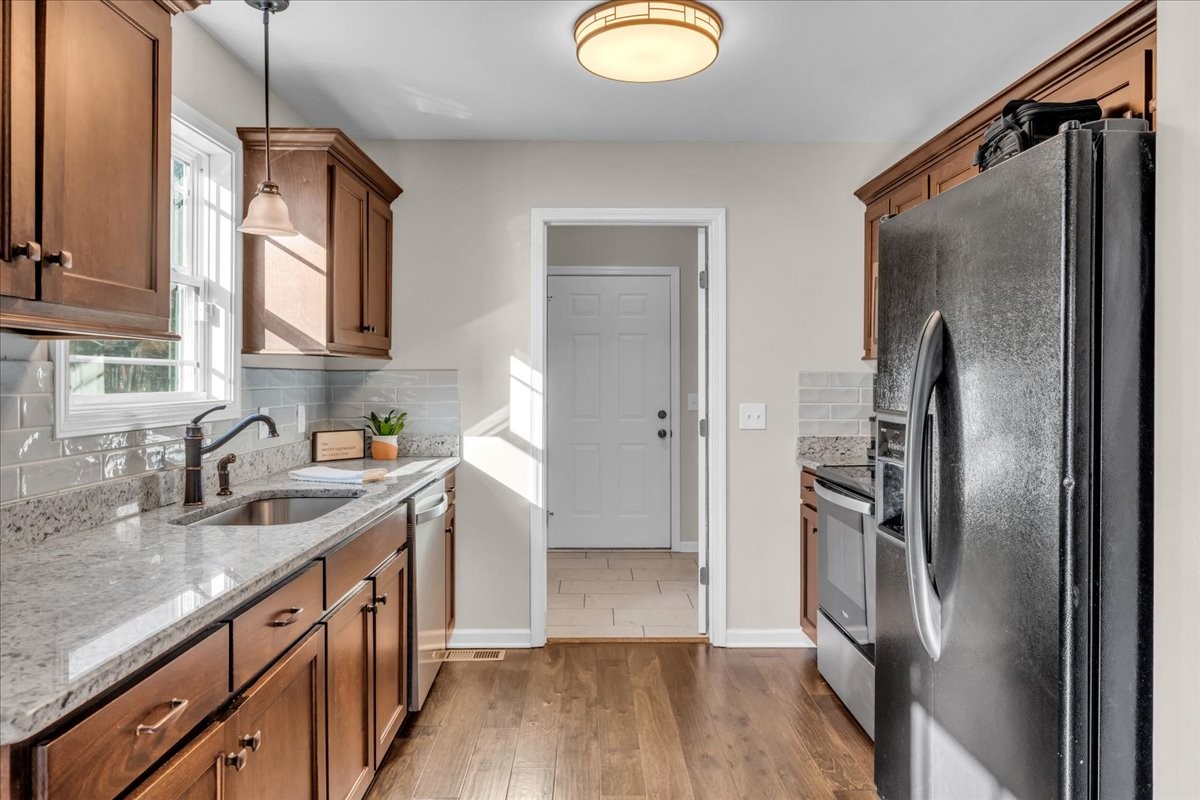 1554 South Spring Street Manchester, TN 37355 - Photo 17 of 33 a kitchen with stainless steel appliances granite countertop a refrigerator a sink and wooden cabinets