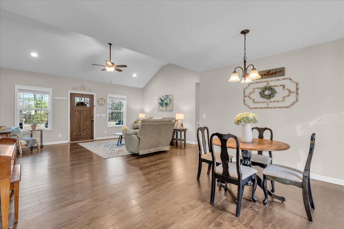 1554 South Spring Street Manchester, TN 37355 - Photo 18 of 33 a view of a dining room and livingroom with furniture wooden floor a chandelier
