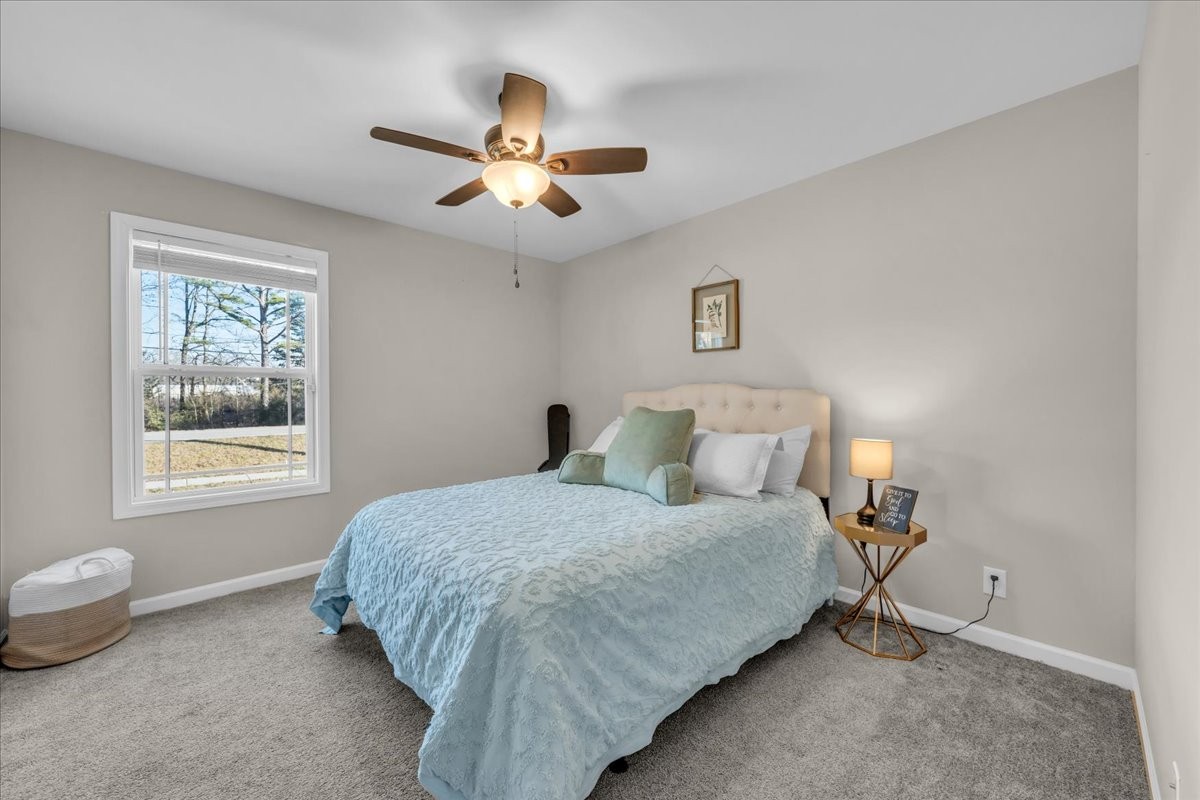 1554 South Spring Street Manchester, TN 37355 - Photo 25 of 33 a bedroom with a bed and a chandelier