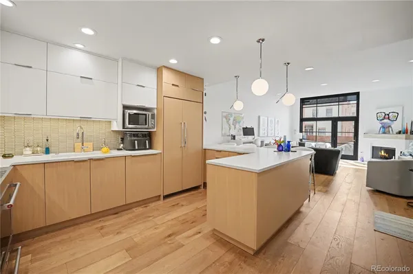 a kitchen with cabinets and wooden floor