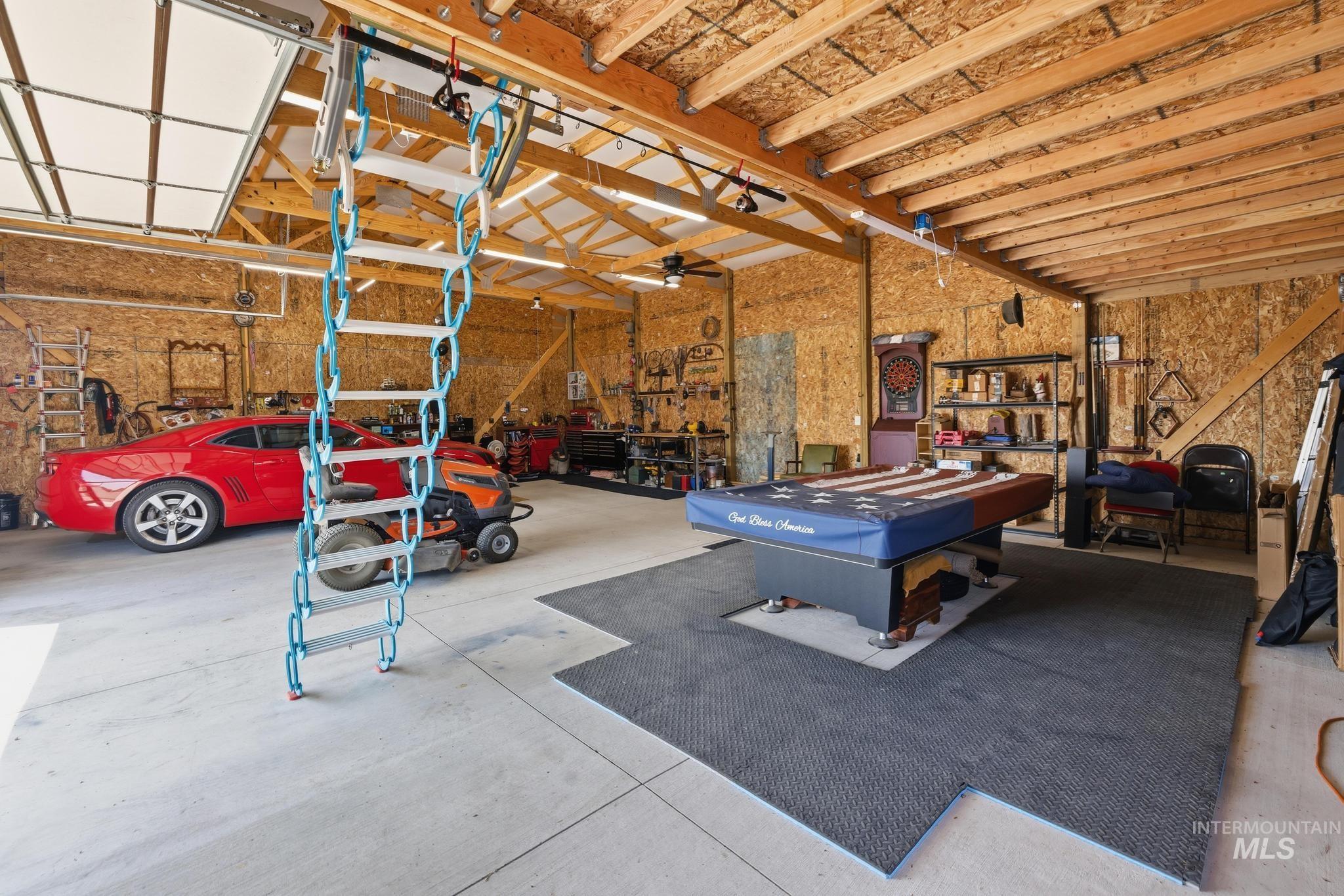178 Syringa Loop Shoshone, ID 83352 - Photo 33 of 35 Spacious garage with exposed wood beam ceiling, concrete flooring, and a folding access ladder