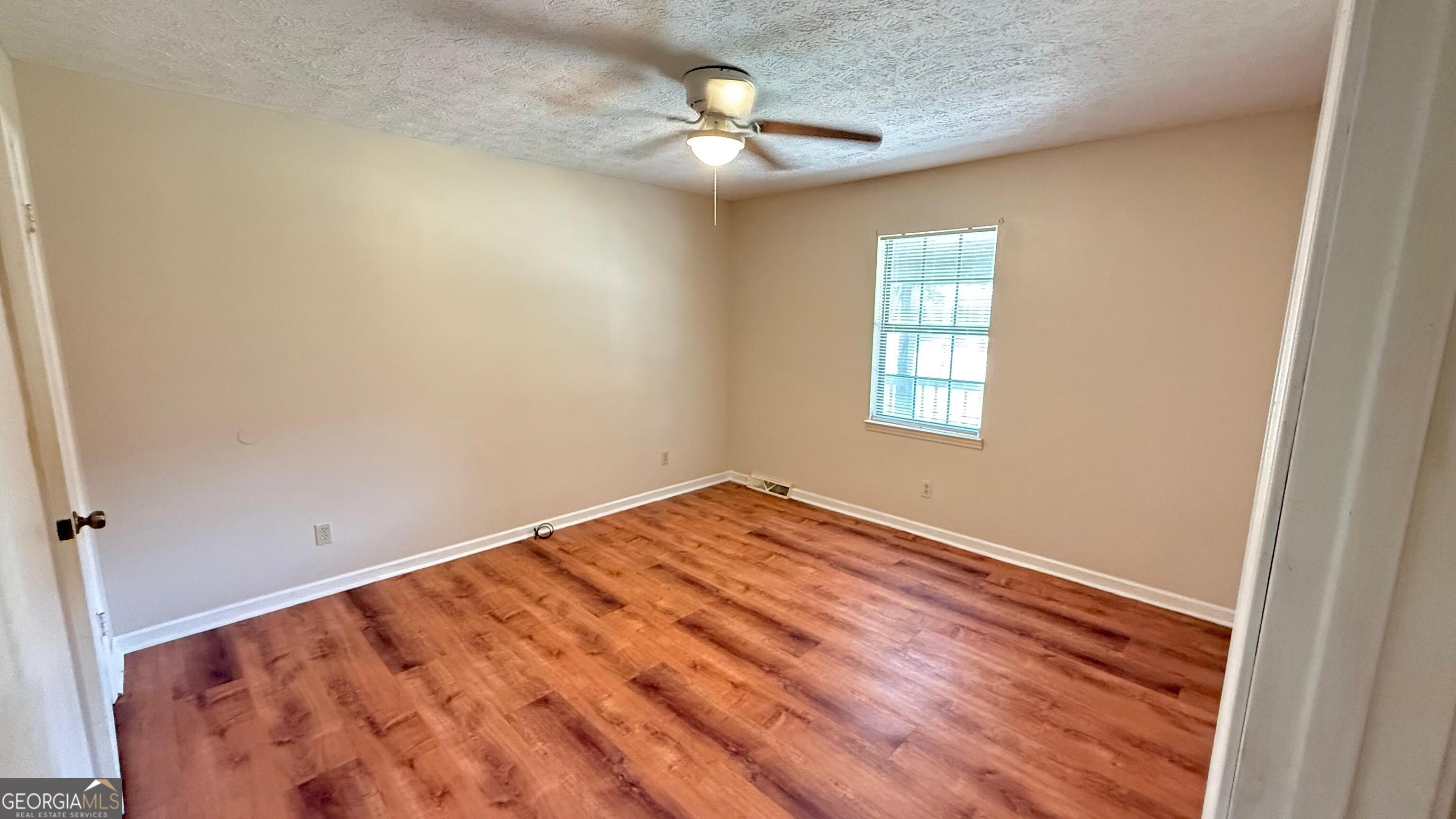 233 Longmeadow Drive Northwest Rome, GA 30165 - Photo 11 of 19 wooden floor in an empty room with a window