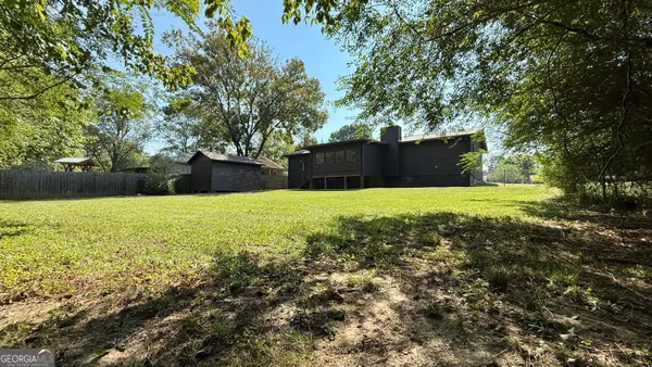 a view of yard with large trees