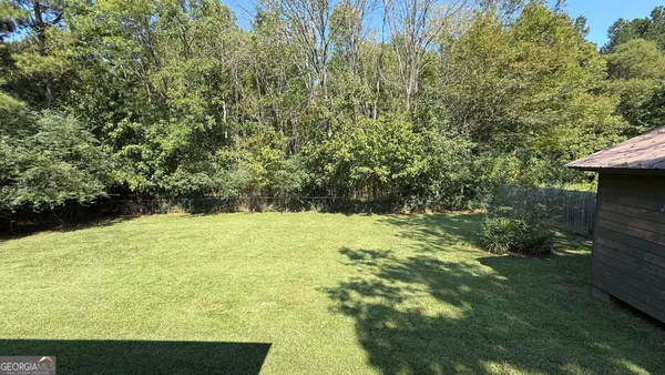 a view of a yard with an outdoor seating