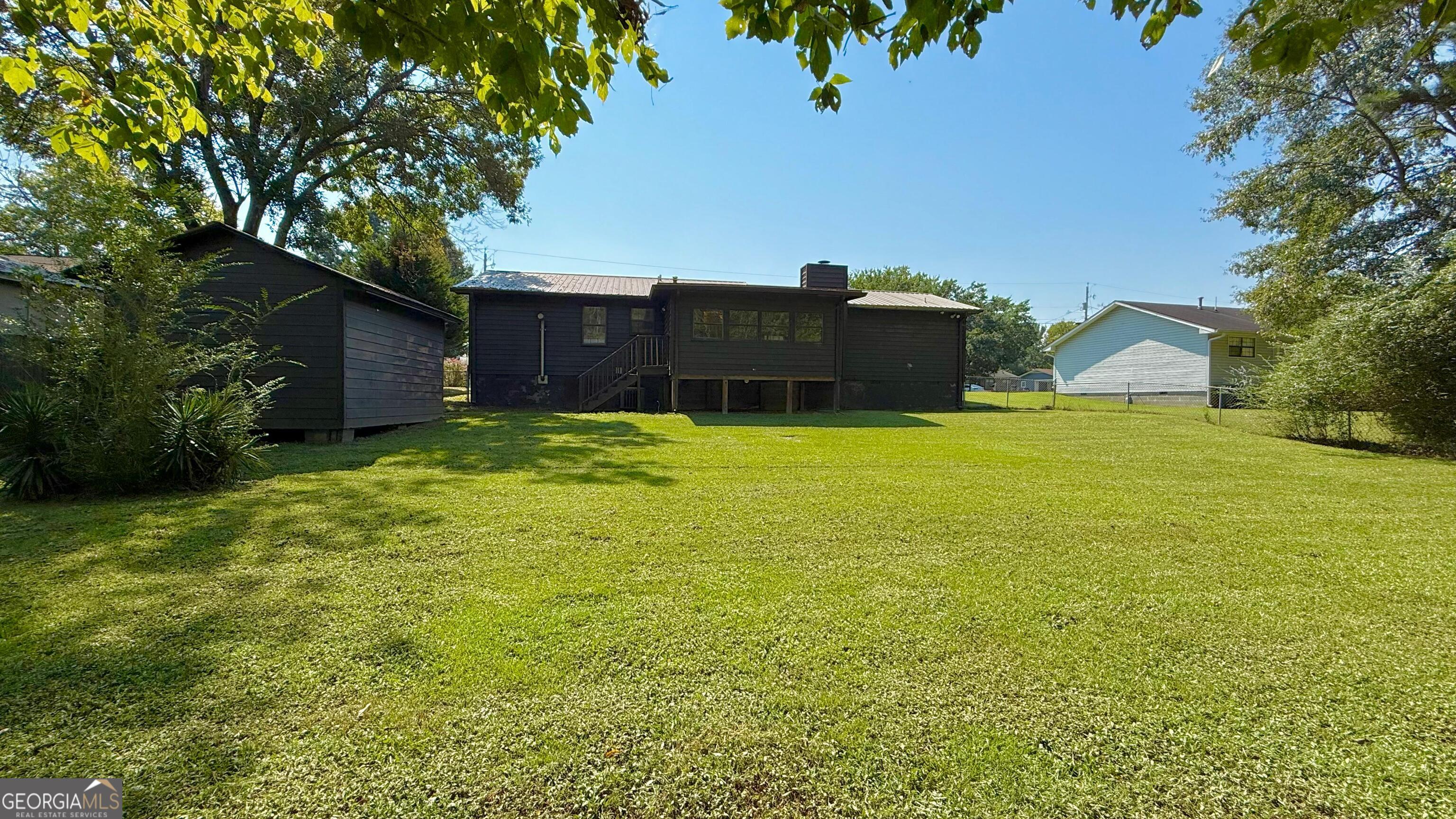 233 Longmeadow Drive Northwest Rome, GA 30165 - Photo 19 of 19 a swimming pool with trees in front of it