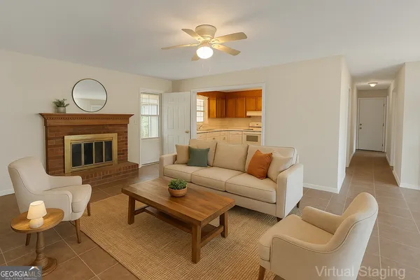 a living room with furniture a fireplace and a ceiling fan