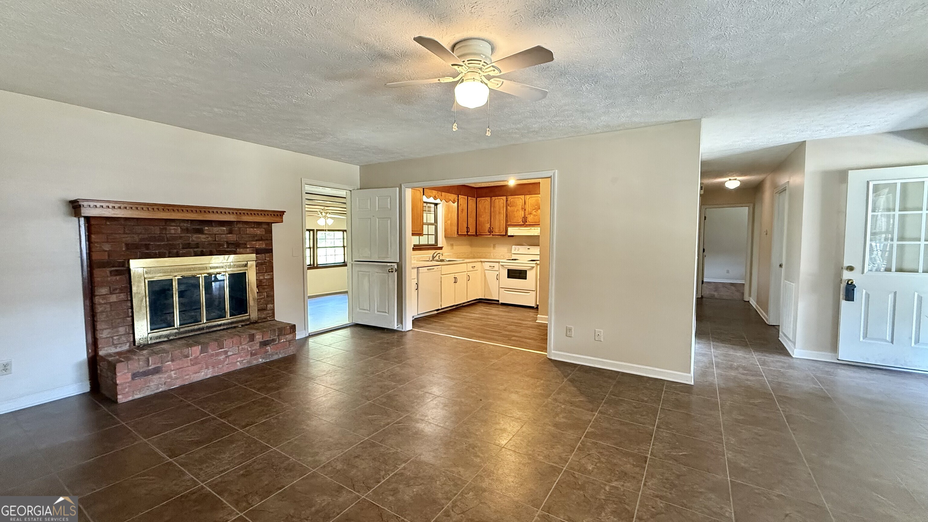 233 Longmeadow Drive Northwest Rome, GA 30165 - Photo 3 of 19 a view of an empty room with a fireplace and a window
