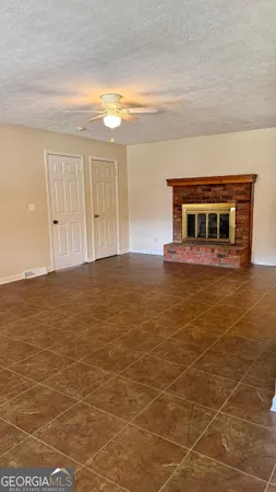 a view of a livingroom with an empty space and a bathroom