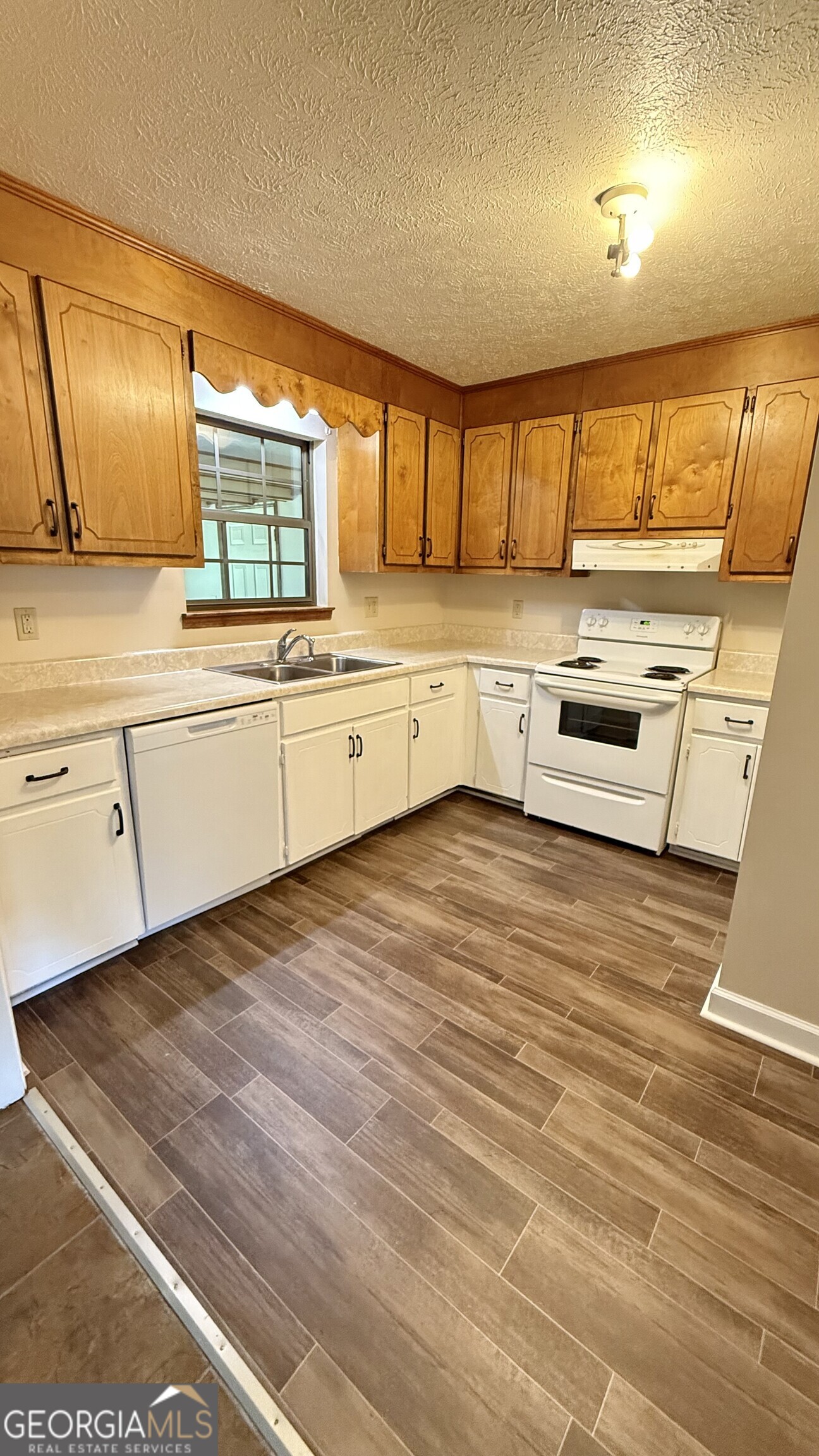233 Longmeadow Drive Northwest Rome, GA 30165 - Photo 6 of 19 a kitchen with stainless steel appliances granite countertop a sink window and cabinets