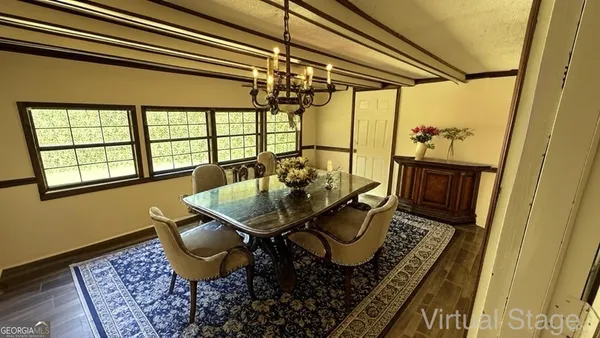 a view of a dining room with furniture window and outside view