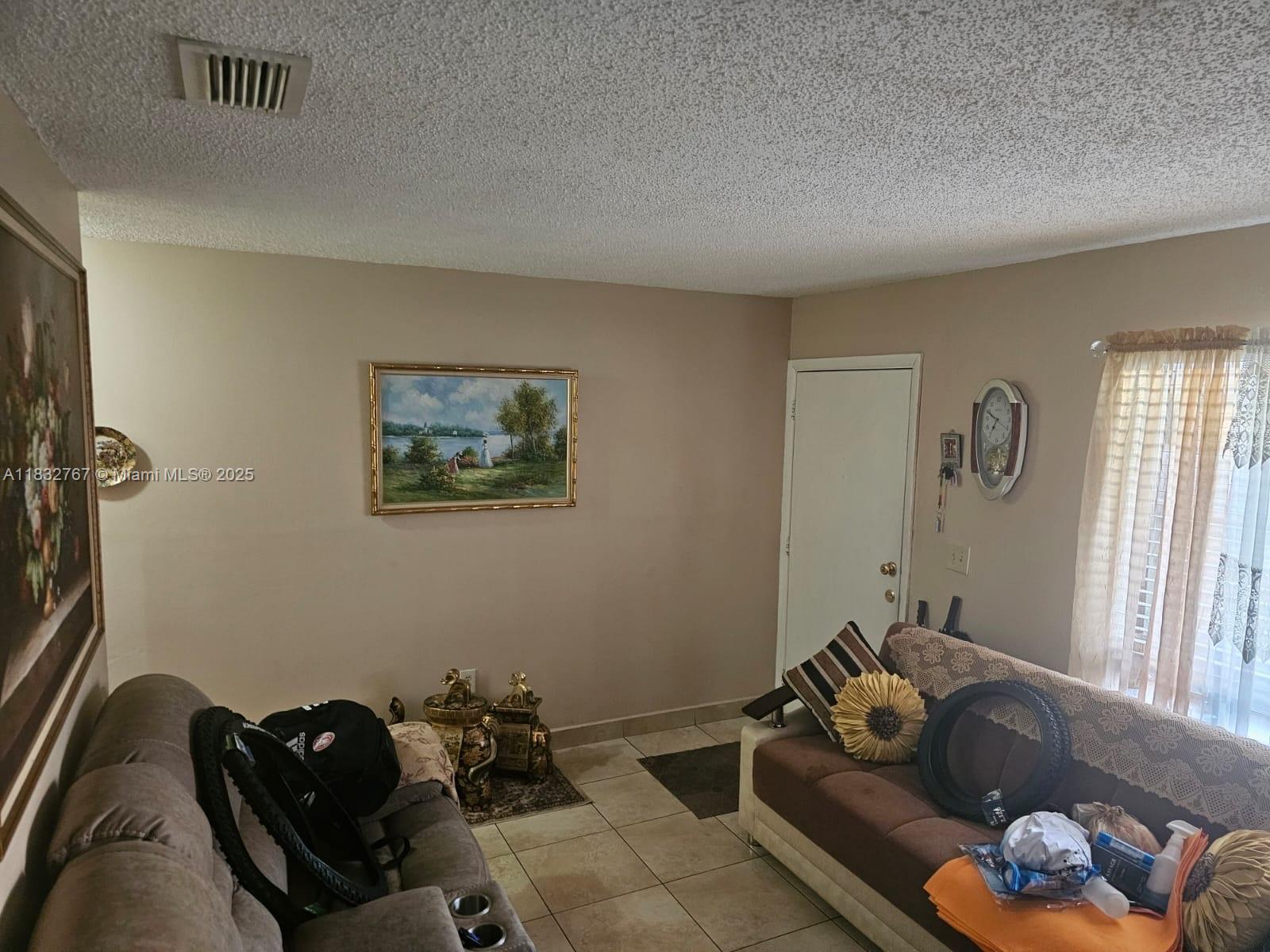 1521 West 42nd Place, Unit 18 Hialeah, FL 33012 - Photo 12 of 14 a living room with furniture