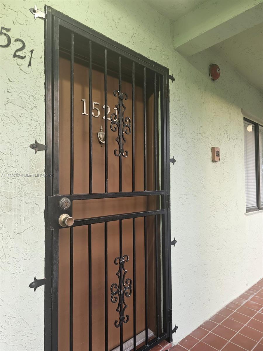 1521 West 42nd Place, Unit 18 Hialeah, FL 33012 - Photo 3 of 14 a view of a porch with a door