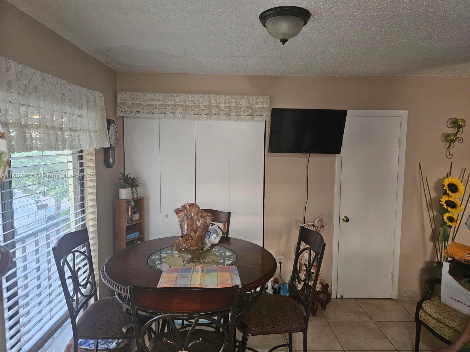1521 West 42nd Place, Unit 18 Hialeah, FL 33012 - Photo 4 of 14 a view of a dining room with furniture and wooden floor