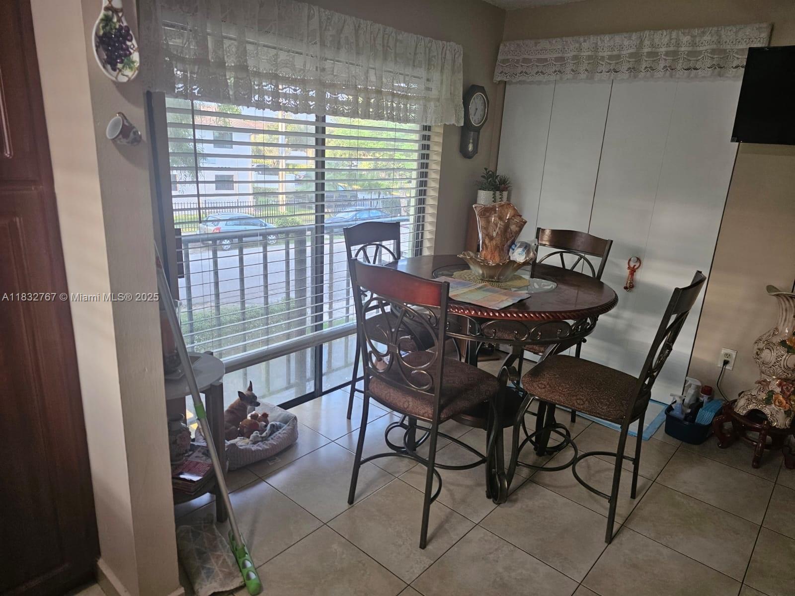 1521 West 42nd Place, Unit 18 Hialeah, FL 33012 - Photo 5 of 14 a view of a dining room with furniture window and outside view