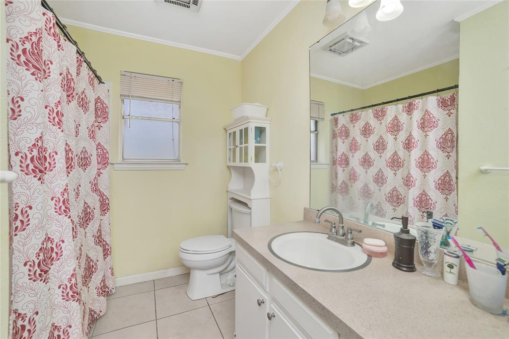6021 Sycamore Creek Road Edgecliff Village, TX 76134 - Photo 26 of 37 Bathroom with toilet, vanity, tile patterned flooring, crown molding, and curtained shower