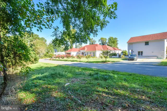 a view of green field with house in the background