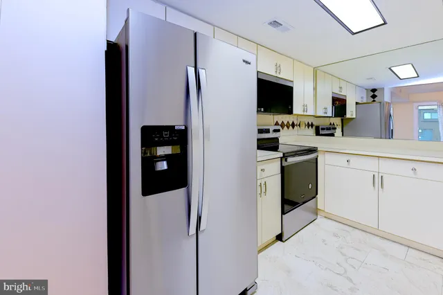 a kitchen with stainless steel appliances a refrigerator sink and stove