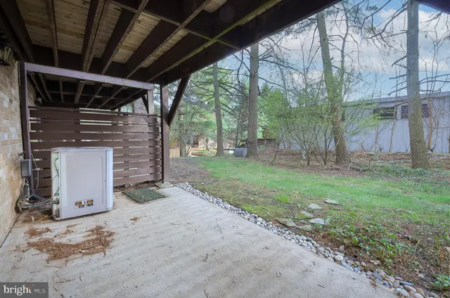 a backyard of a house with barbeque oven table and chairs