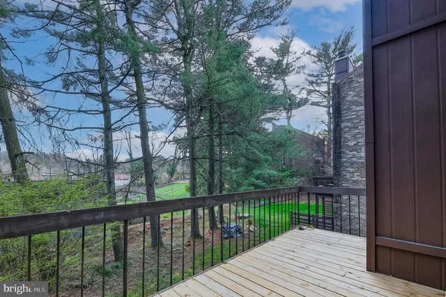 a balcony with wooden floor and fence