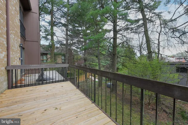 a view of balcony with wooden floor and fence