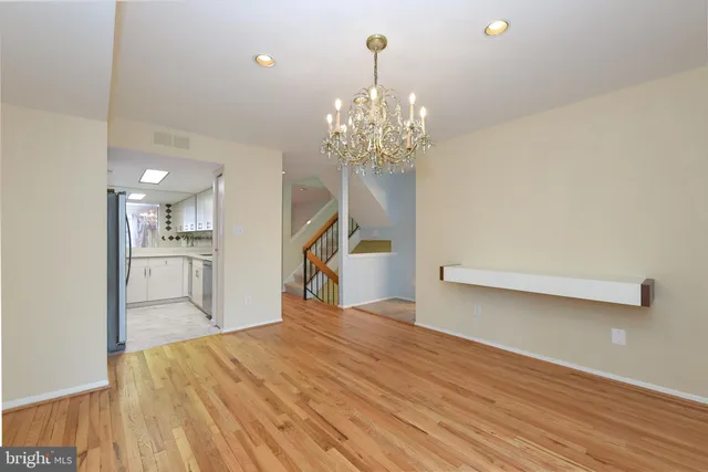 a view of a kitchen with wooden floor and a chandelier