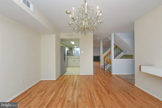 a view of a room with wooden floor staircase and hallway