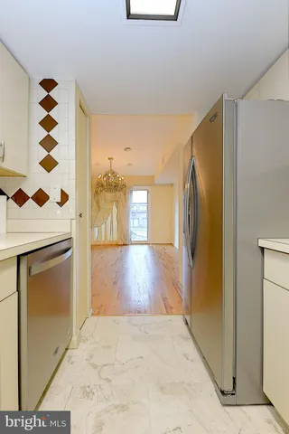 a view of a hallway with wooden floor and a fireplace