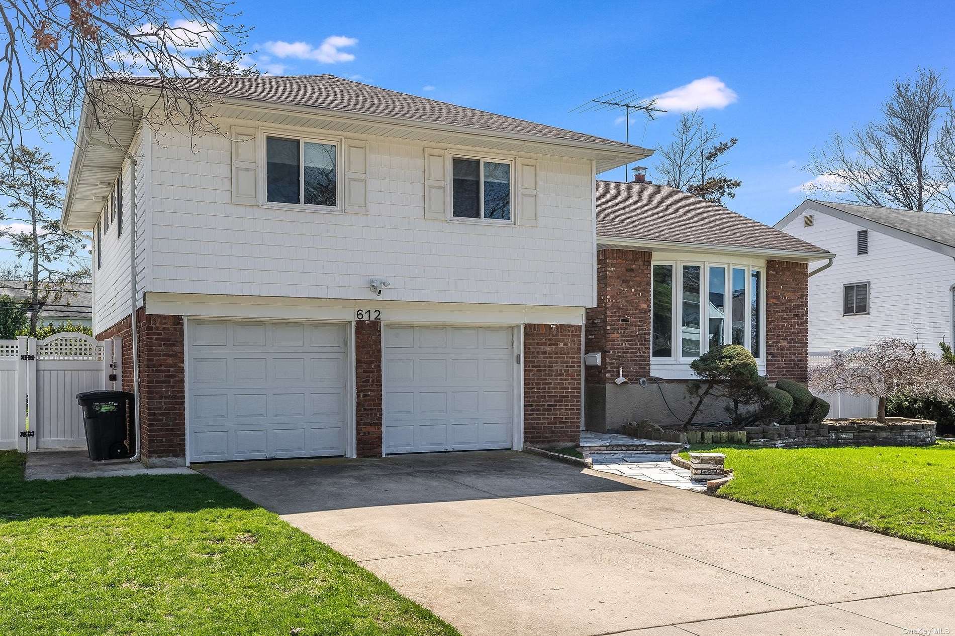 612 Nutley Place Valley Stream, NY 11581 - Photo 1 of 1 a front view of a house with a yard and garage
