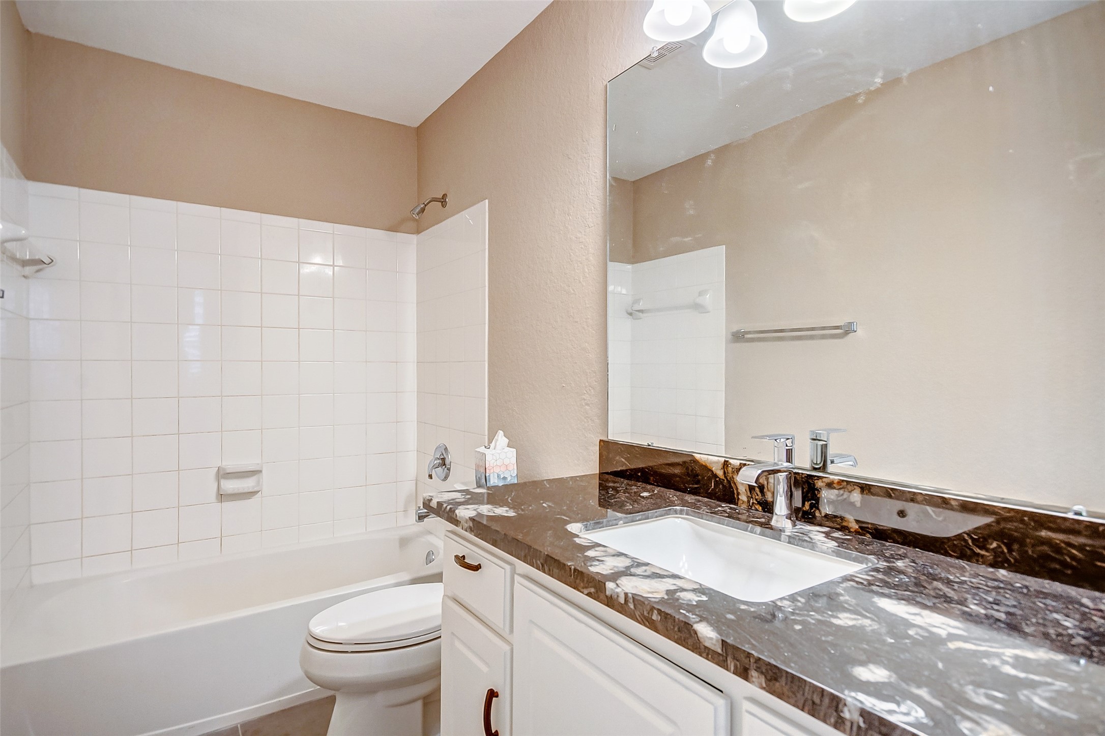 2022 Ridge Wood Lane Sugar Land, TX 77479 - Photo 15 of 21 a bathroom with a granite countertop sink a toilet and a bathtub