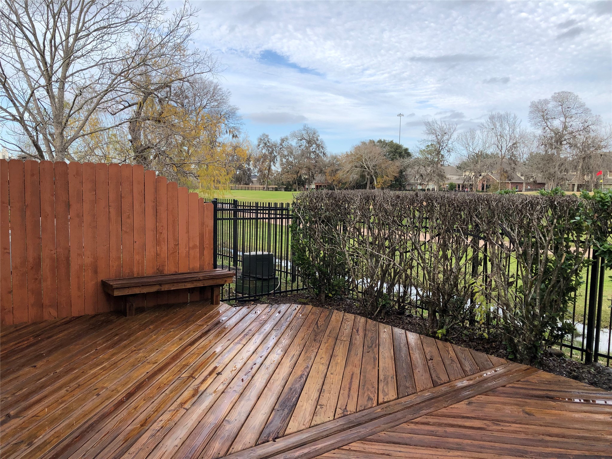 2022 Ridge Wood Lane Sugar Land, TX 77479 - Photo 21 of 21 a view of balcony with wooden floor and fence and trees