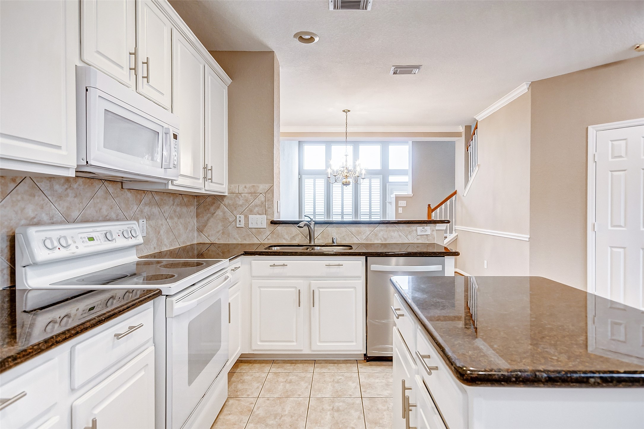 2022 Ridge Wood Lane Sugar Land, TX 77479 - Photo 4 of 21 a kitchen with stainless steel appliances granite countertop a sink stove and cabinets