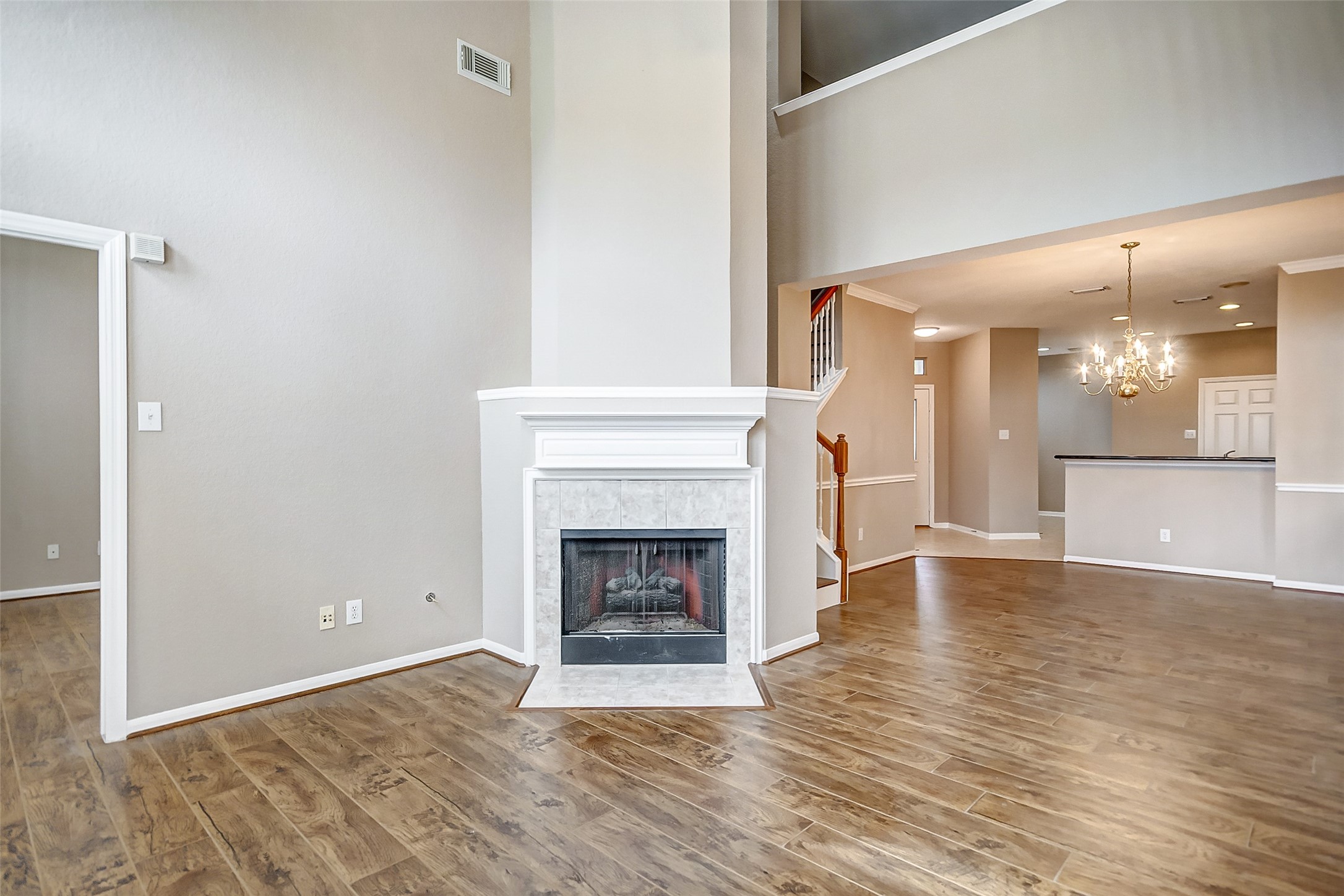 2022 Ridge Wood Lane Sugar Land, TX 77479 - Photo 7 of 21 a view of a livingroom with wooden floor and a fireplace