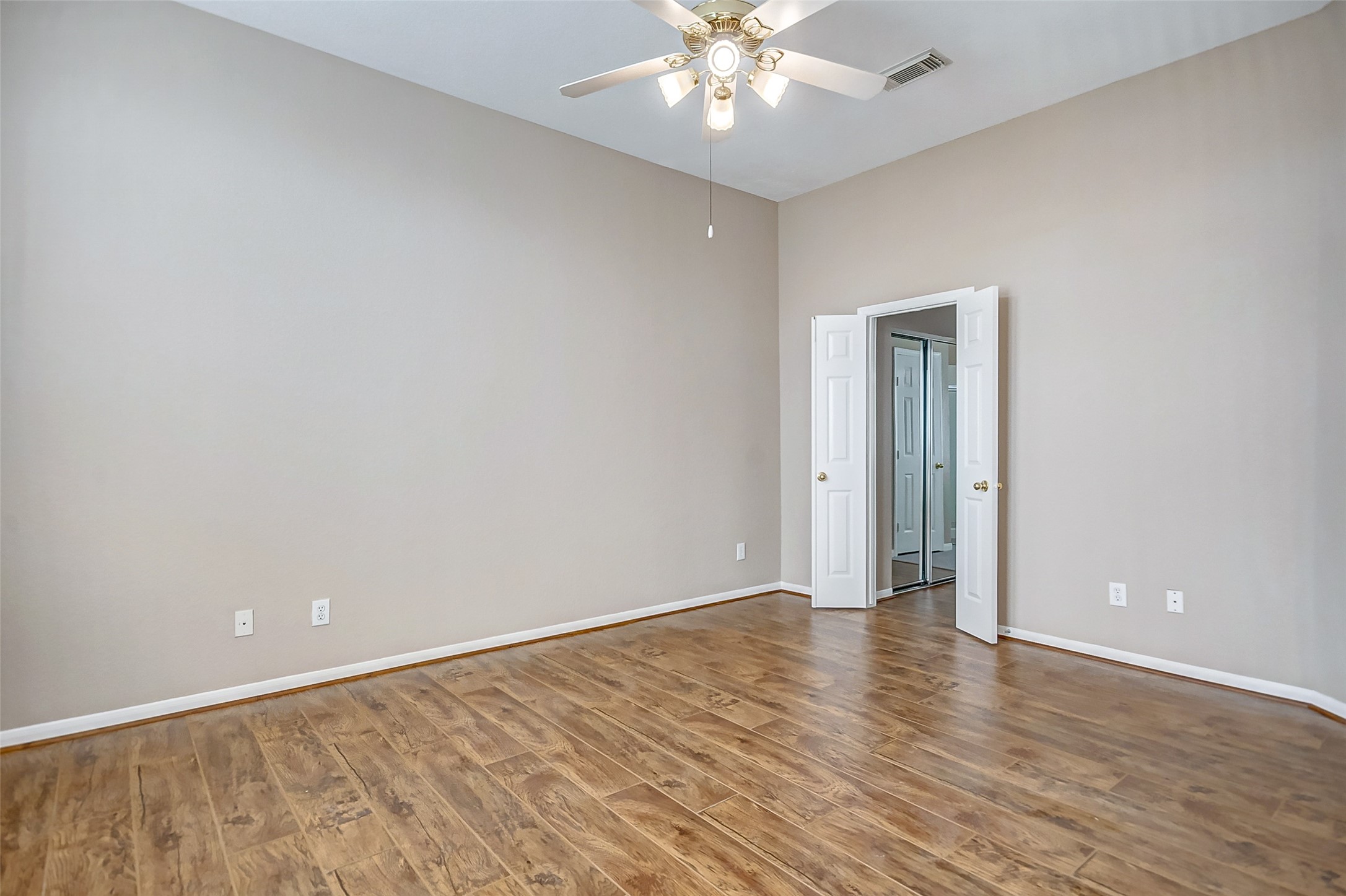 2022 Ridge Wood Lane Sugar Land, TX 77479 - Photo 9 of 21 a view of an empty room with wooden floor
